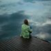 woman sitting on wooden planks