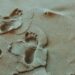 person foot prints on sands photo