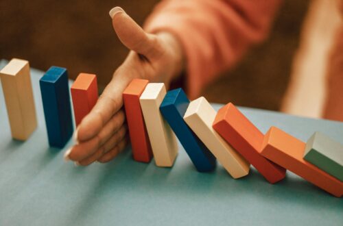 hand stopping domino effect